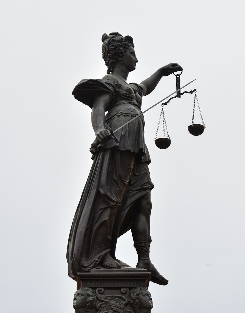 A statue of lady justice holding a scale of justice
